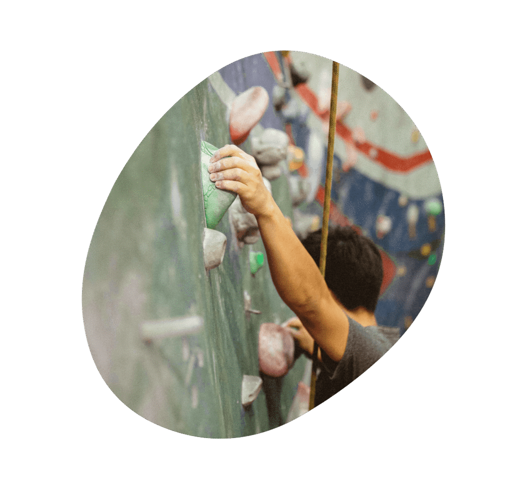 Person climbing an indoor rock wall
